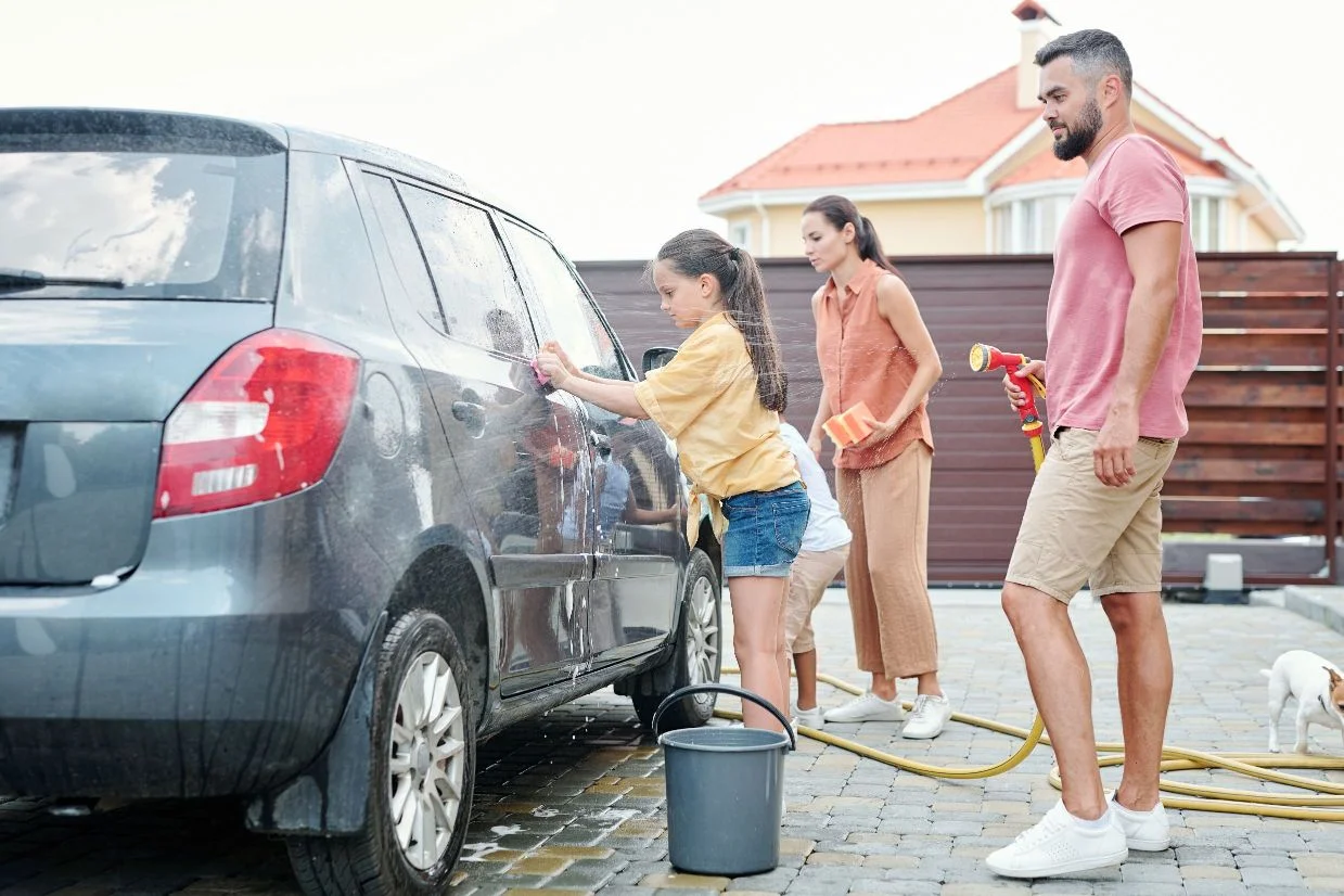 family washing a car